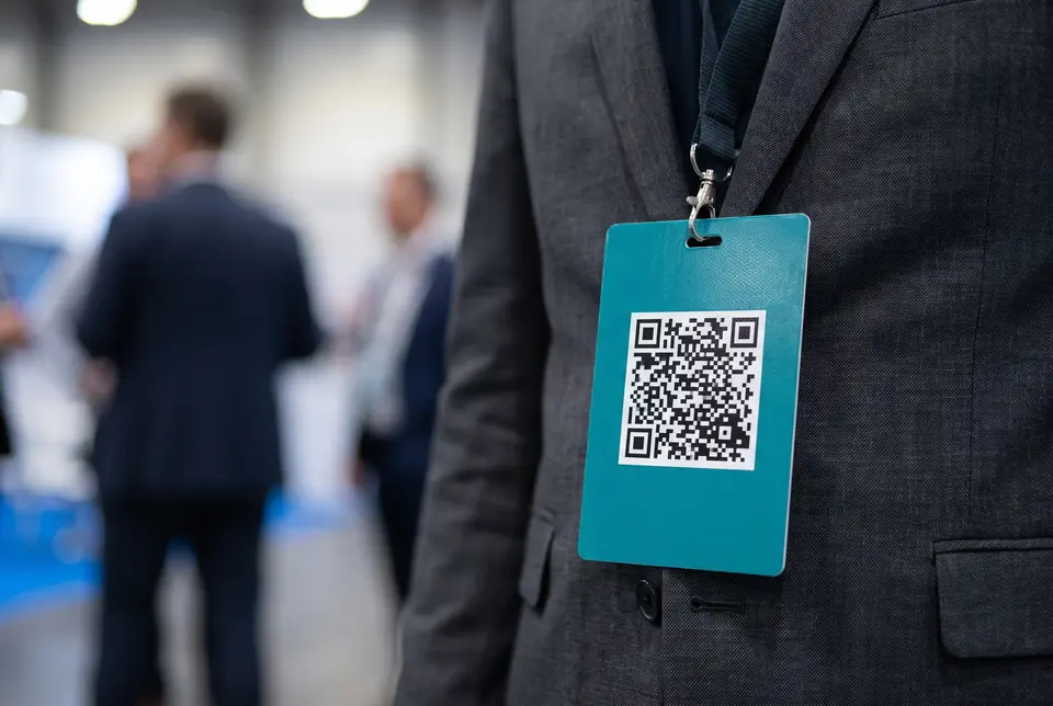 Conference badge and lanyard with a scannable professional profile QR